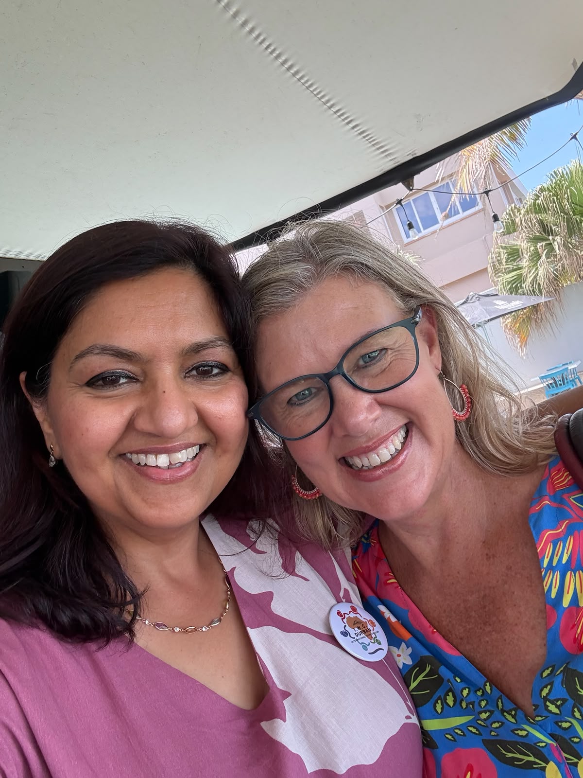 Ambika and Belinda smiling together at an IWC gathering