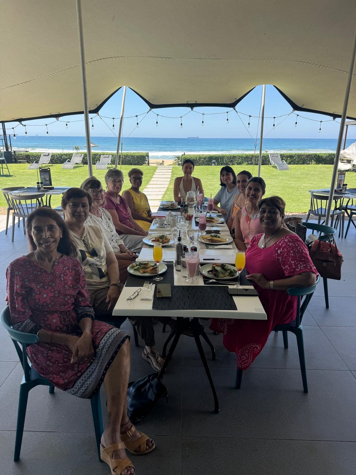 IWC Durban committee members at a seaside leaders' brunch overlooking the Indian Ocean
