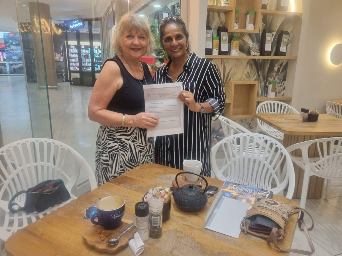 IWC Durban raffle winner receiving her Burnham House prize certificate
